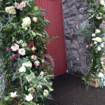 flowers surrounding red door