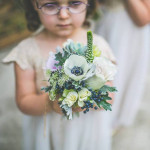 young child holding flowers